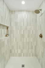 Full bath with recessed lighting, a tile shower, and visible vents
