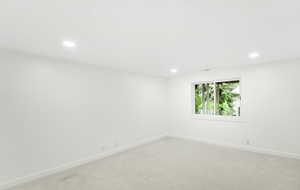 Empty room with recessed lighting, baseboards, and light carpet