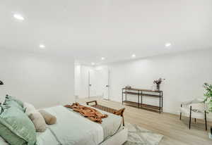 Bedroom with baseboards, recessed lighting, and light wood-style flooring