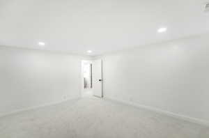 Unfurnished room featuring recessed lighting, baseboards, and light colored carpet
