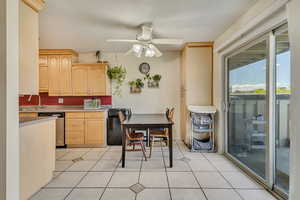 Kitchen featuring a sink, light brown cabinets, a ceiling fan, and dishwasher