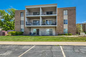 View of property with uncovered parking