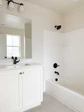 Bathroom with visible vents, vanity, tile patterned floors, and shower / bath combination
