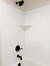 Details featuring shower / bathing tub combination