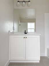 Full bath featuring a tub to relax in, visible vents, tile patterned floors, and baseboards
