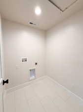 Clothes washing area featuring washer hookup, baseboards, electric dryer hookup, and laundry area