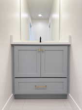Room details with baseboards, vanity, and recessed lighting
