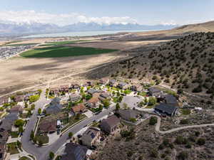 Birds eye view of property featuring a water and mountain view and a residential view