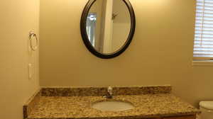 Half bathroom with toilet and vanity