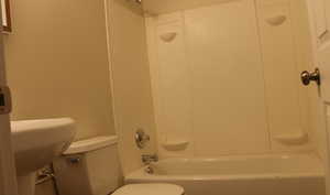 Bathroom with shower / bathtub combination and toilet