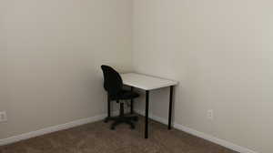 Unfurnished office with light colored carpet and baseboards