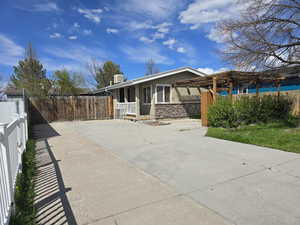 Back of house featuring covered porch and fence