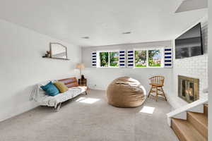 Living area featuring and a brick fireplace