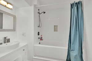 Full bath in the basement with vanity and tub/shower combo