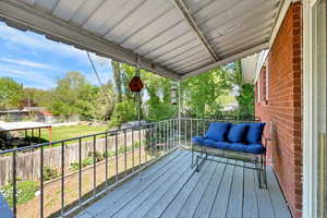 Wooden deck off the dining room with a fenced backyard