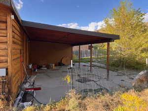 View of patio featuring fence and a carport