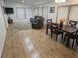 Dining area with baseboards, ceiling fan, recessed lighting, and light wood-style flooring