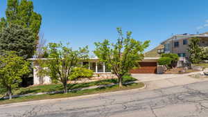 Obstructed view of property featuring an attached garage and concrete driveway