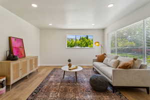 Living room featuring recessed lighting, a wealth of natural light, and light wood vinyl floors