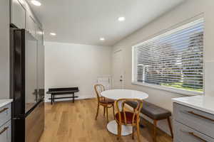 Dining room with recessed lighting and light wood vinyl floors