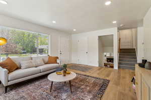 Living area featuring recessed lighting, new light wood vinyl flooring