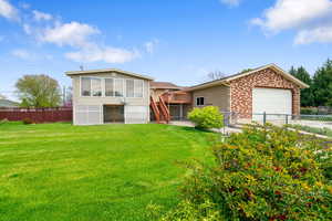 View of back of home with rear  garage door