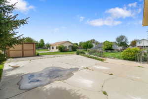 Exterior space with fence,  a shed, a rear drive