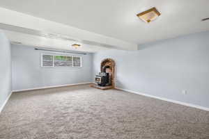 Family room with new carpet and wood stove.