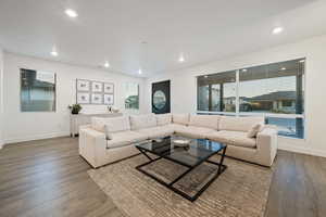 Living area featuring recessed lighting, baseboards, and wood finished floors