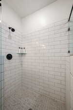 Bathroom featuring a tile shower