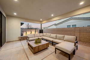 Patio terrace at dusk with a fenced backyard and outdoor lounge area