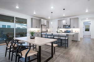 Dining area with recessed lighting, baseboards, a healthy amount of sunlight, and light wood-style floors