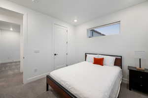 Bedroom featuring carpet floors, baseboards, a closet, and recessed lighting