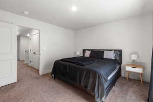 Primary carpeted bedroom with baseboards