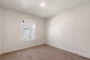 Bedroom 3 -  featuring light carpet and baseboards