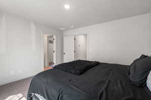 Primary Bedroom featuring baseboards and carpet