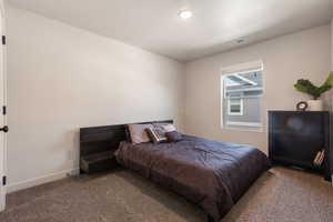 Bedroom 2 with carpet floors, baseboards, and visible vents