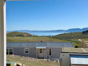 View of front of home with a water and mountain view