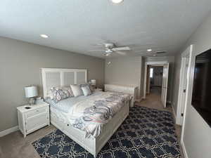 Bedroom with carpet floors, recessed lighting, a textured ceiling, and baseboards