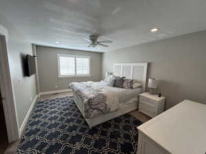 Bedroom featuring recessed lighting, a textured ceiling, carpet, and a ceiling fan
