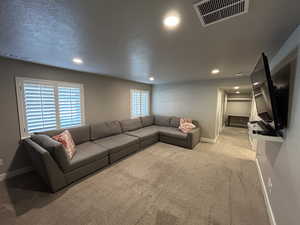 Living area with visible vents, recessed lighting, baseboards, and carpet floors