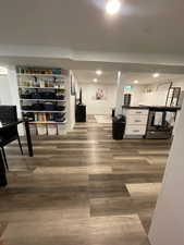 Interior space featuring baseboards, dark wood-type flooring, and recessed lighting