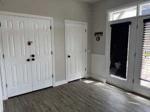 Foyer entrance with wood finished floors, plenty of natural light, and baseboards