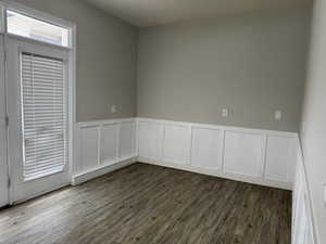 Empty room with wood finished floors and wainscoting