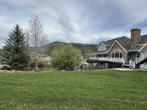 View of grassy yard with a mountain view