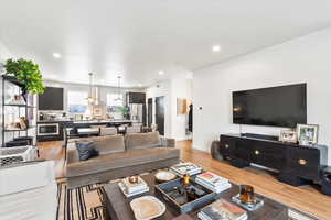 Living room featuring light wood-type flooring, recessed lighting, and baseboards
