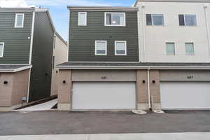 Exterior space with brick siding and an attached garage