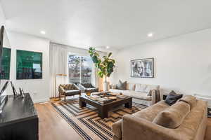Living room with recessed lighting, light wood finished floors, and baseboards
