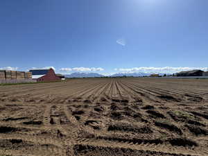 View of yard with a mountain view, a rural view, and fence