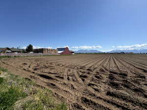 View of yard featuring a mountain view, a rural view, and fence